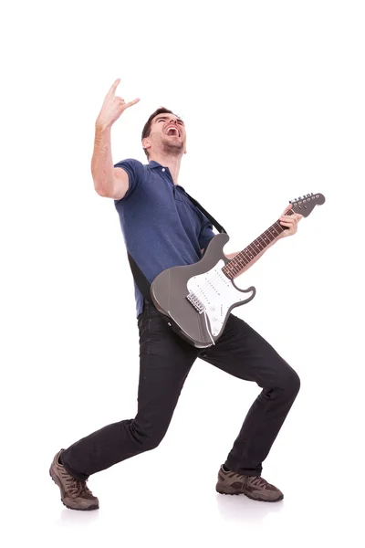 Guitarist making a rock and roll gesture — Stock Photo, Image