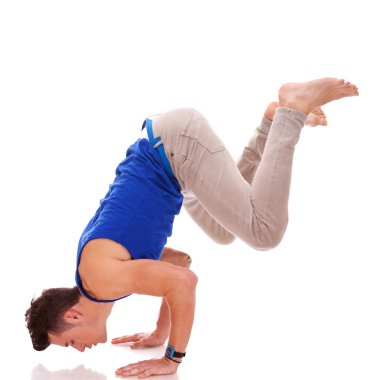 Barefoot casual man doing a handstand clipart