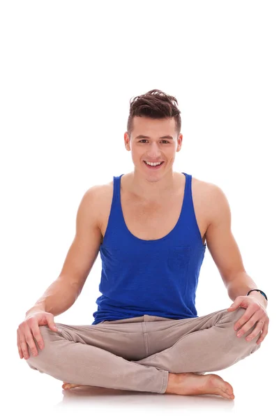 Young barefoot man in a yoga position — Stock Photo, Image