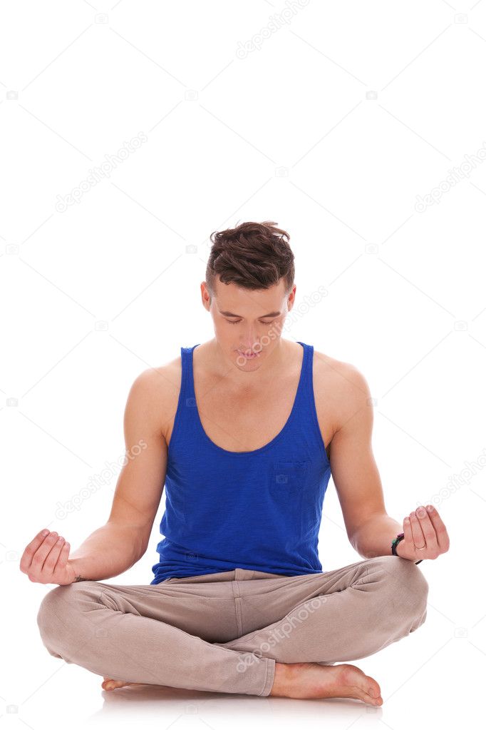 Handsome man meditating in lotus position