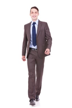 Young business man is walking towards the camera clipart