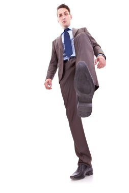 Business man stepping on something clipart