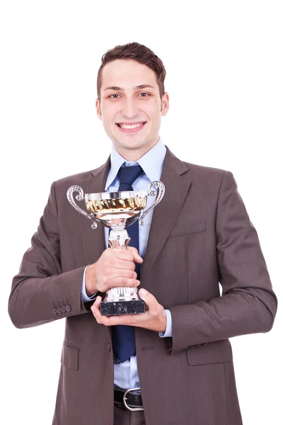 Переможець бізнесмен тримає свою нагороду — стокове фото