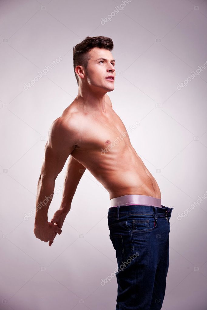 Muscular man with no shirt stretching