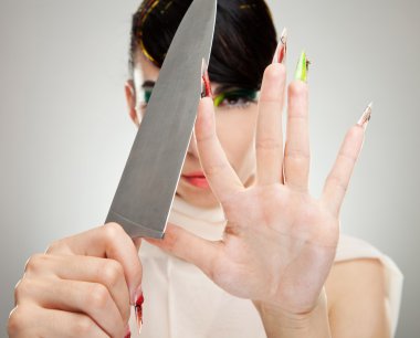 Woman sharpening her nails with knife clipart