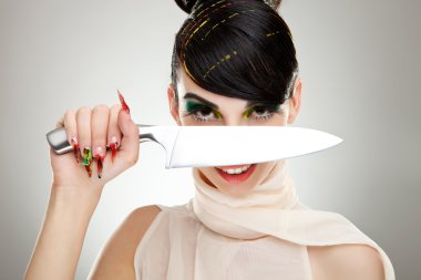 Woman with a knife over her face clipart