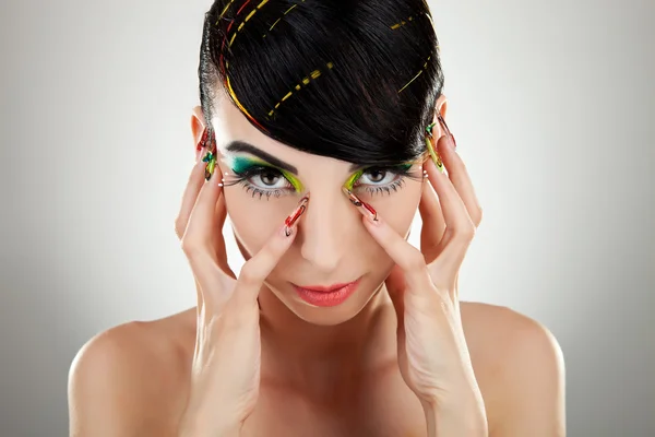 Woman face with color makeup and manicure — Stock Photo, Image