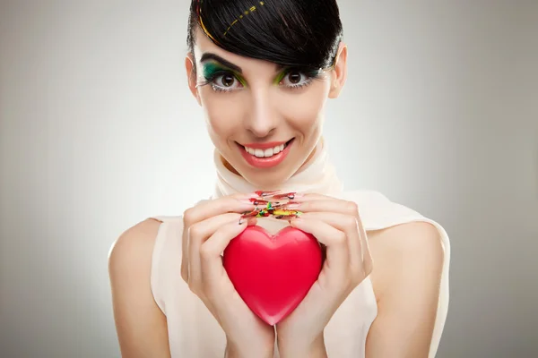 Young woman holding a heart — Stock Photo, Image