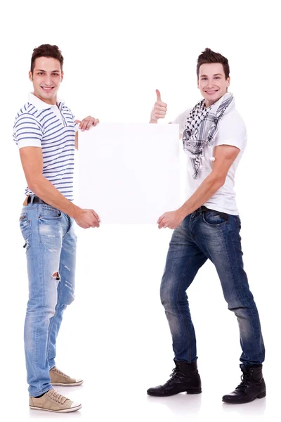 Two young men holding a blank board Stock Photo