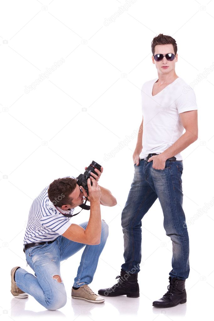 Young man wearing sunglasses being photographed