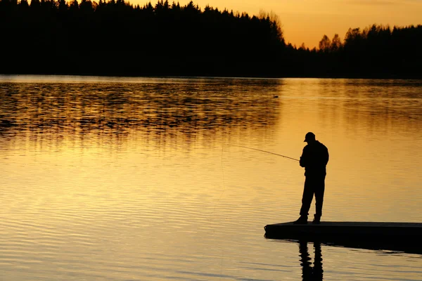 Pesca ao pôr-do-sol Fotos De Bancos De Imagens