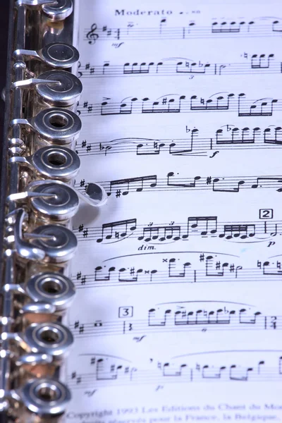 Silver flute on flute sheet music — Stock Photo, Image