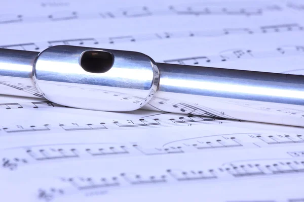 Silver flute on flute sheet music — Stock Photo, Image