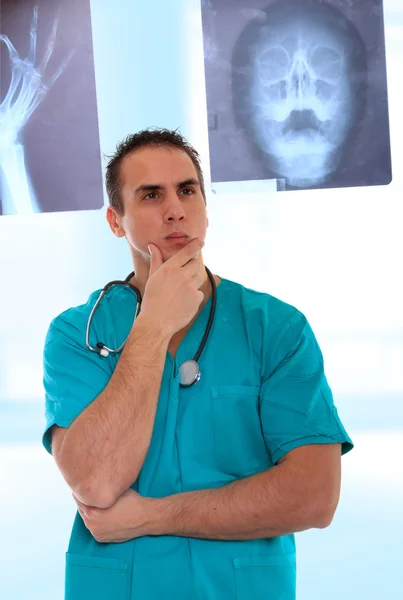 Male doctor looking at xrays. Stock Photo