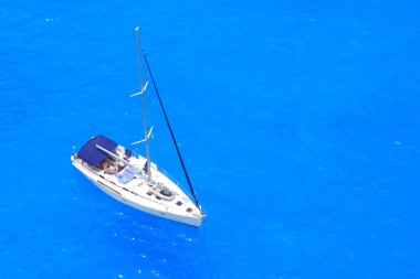 Boat in deep blue water clipart