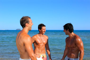 Üç genç adam sahilde