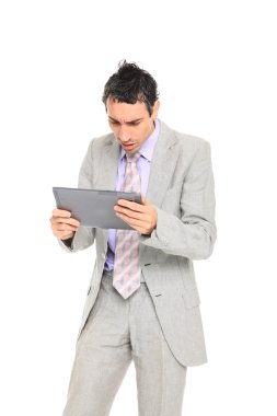 Young business man standing using a tablet