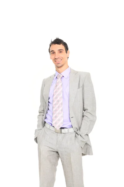 Young business man standing with hands in pocket — Stock Photo, Image
