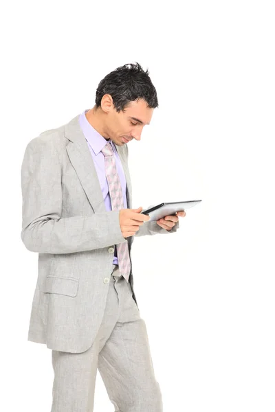 Young business man standing using a tablet — Stok fotoğraf