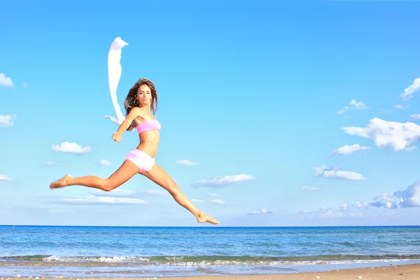 Nő jumping a strandon — Stock Fotó