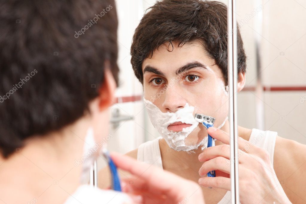 Young man shaving