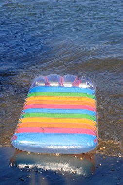 Air mattress on the beach clipart