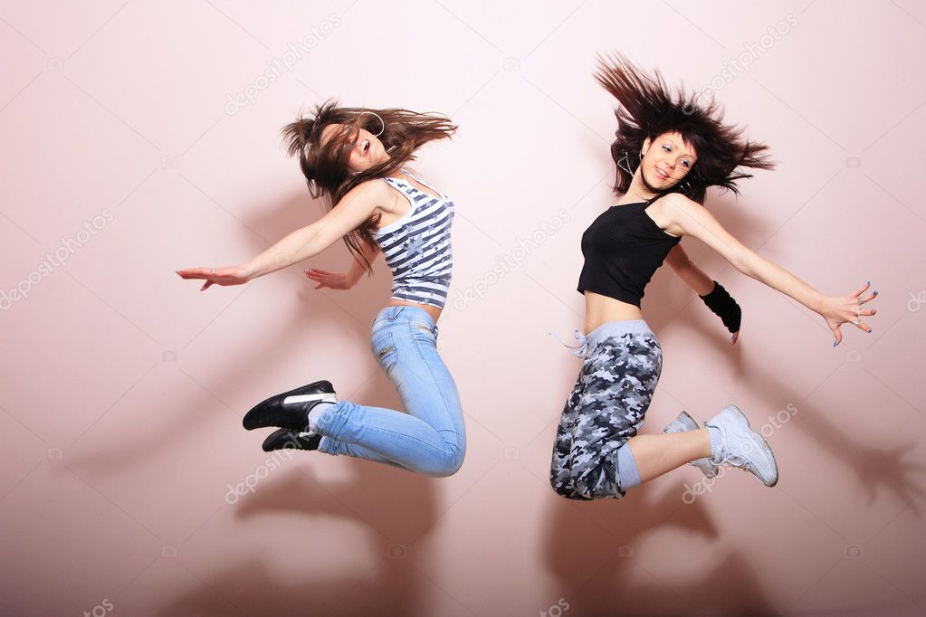 Two beautiful girls jumping
