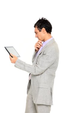 Young business man standing using a tablet