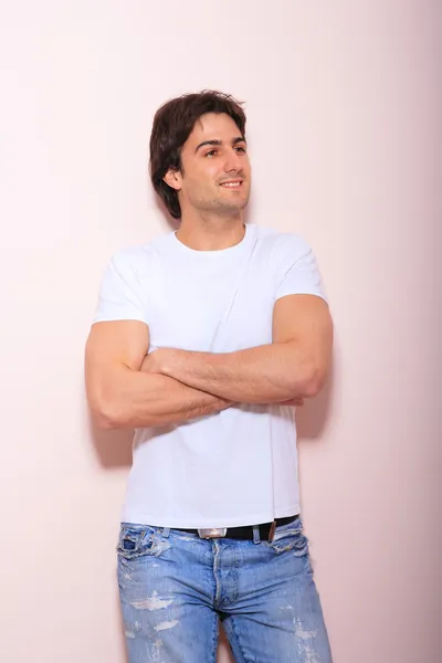Young man against pink background — Stock Photo, Image