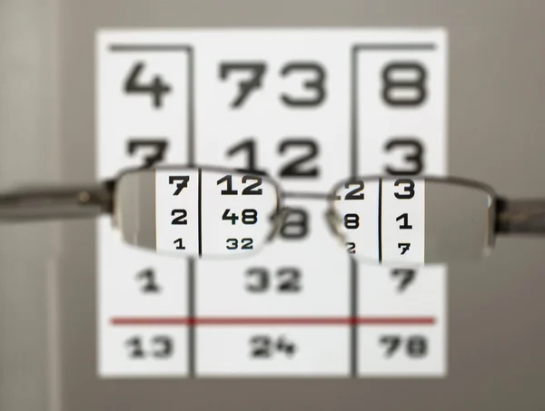 Eye test chart with eyeglasses — Stock Photo, Image