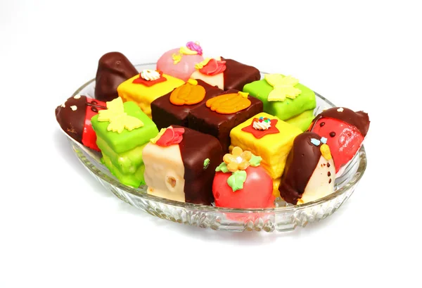 Various colorful marzipan cakes on glass plate — Stock Photo, Image