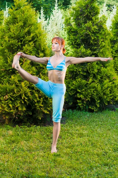 Slim woman doing yoga exercises — Stock Photo, Image
