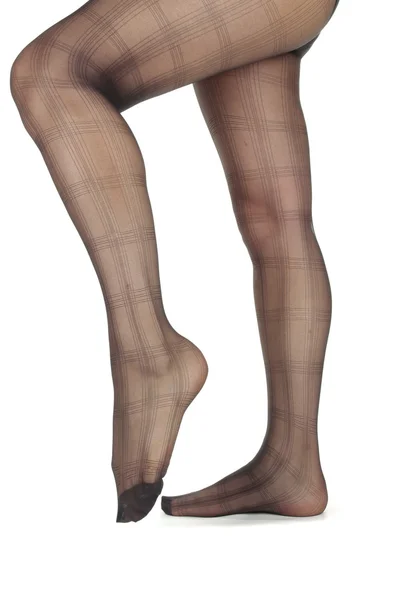 Mujer piernas usando mallas sobre fondo blanco — Foto de Stock