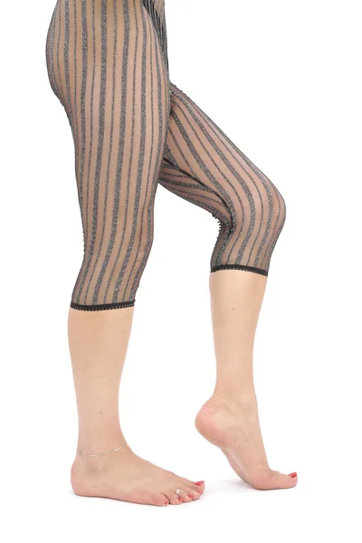 Woman legs wearing leggings over white background — Stock Photo, Image