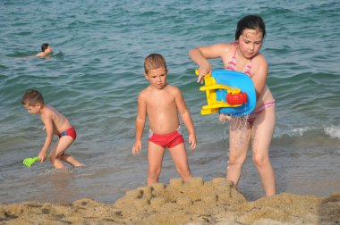 Happy children at the beach clipart