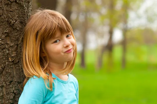 Retrato de menina tímida sorridente posando na natureza no belo dia de primavera — Fotografia de Stock
