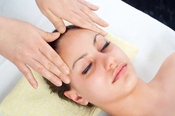 Beautiful young women getting a face massage — Stock Photo, Image