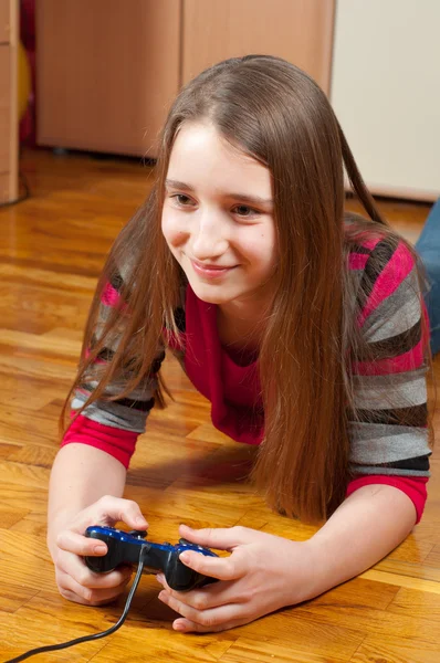 stock image Happy teenage girl playing computer games using game controller