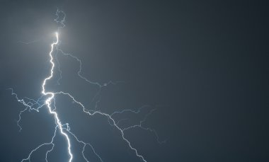 Powerful lightning strikes the ground during big storm. Slight noise due to long exposure clipart