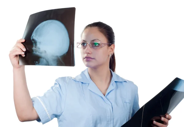 Jonge vrouwelijke arts kijken naar x-ray foto van patiënten schedel — Stockfoto