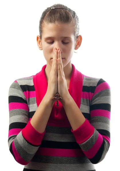 Beautiful young girl praying while holding small leather cross — Stock Photo, Image