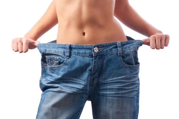 Detail of athletic muscular female body in old trousers after loosing weigh — Stock Photo, Image