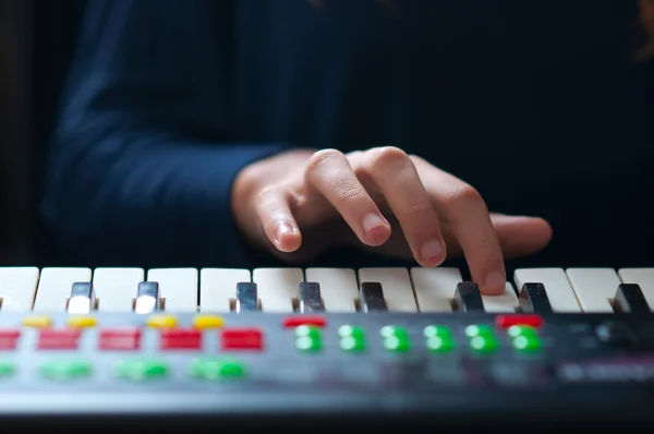 Stock image Child play on synthesizer