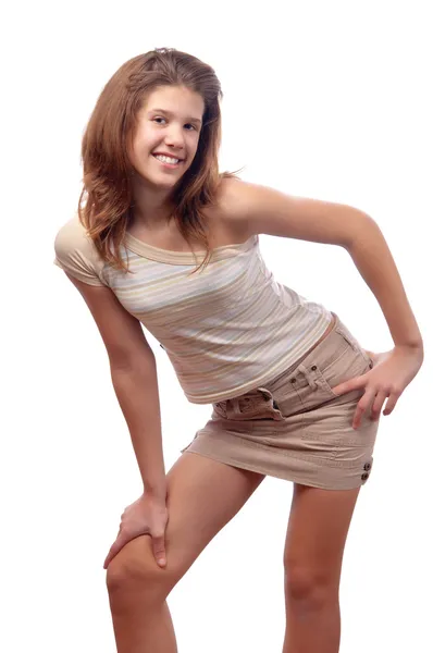 Beautiful smiling teenage girl in short brown skirt — Stock Photo, Image