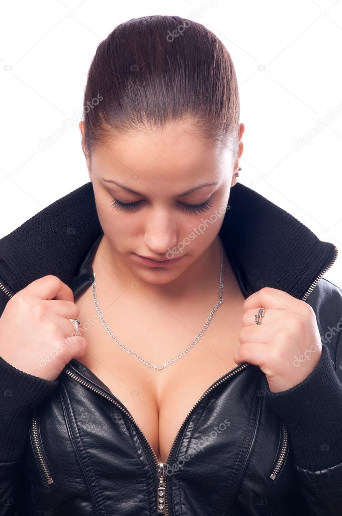 Beautiful girl in black leather jacket looking at her cleavage