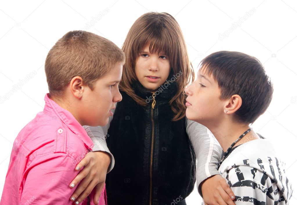 Teenage girl trying to separate two angry teenage boys