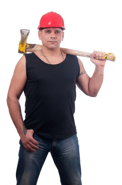 Proud lumberjack posing with red helmet on his head and big old ax — Stock Photo, Image