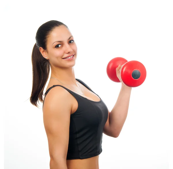 Mujer atractiva joven haciendo ejercicio con mancuerna roja aislada en blanco — Foto de Stock