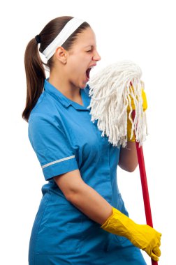 Beautiful young cleaning lady pretending to be a singer isolated on whiteBeautiful young cleaning lady pretending to be a singer isolated on white clipart