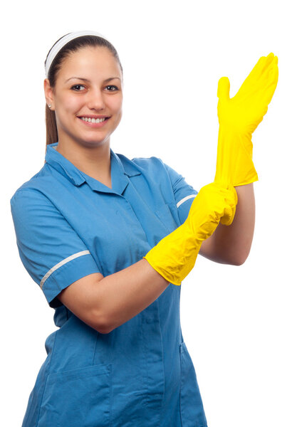 Smiling cleaning lady putting on the rubber gloves isolated on white